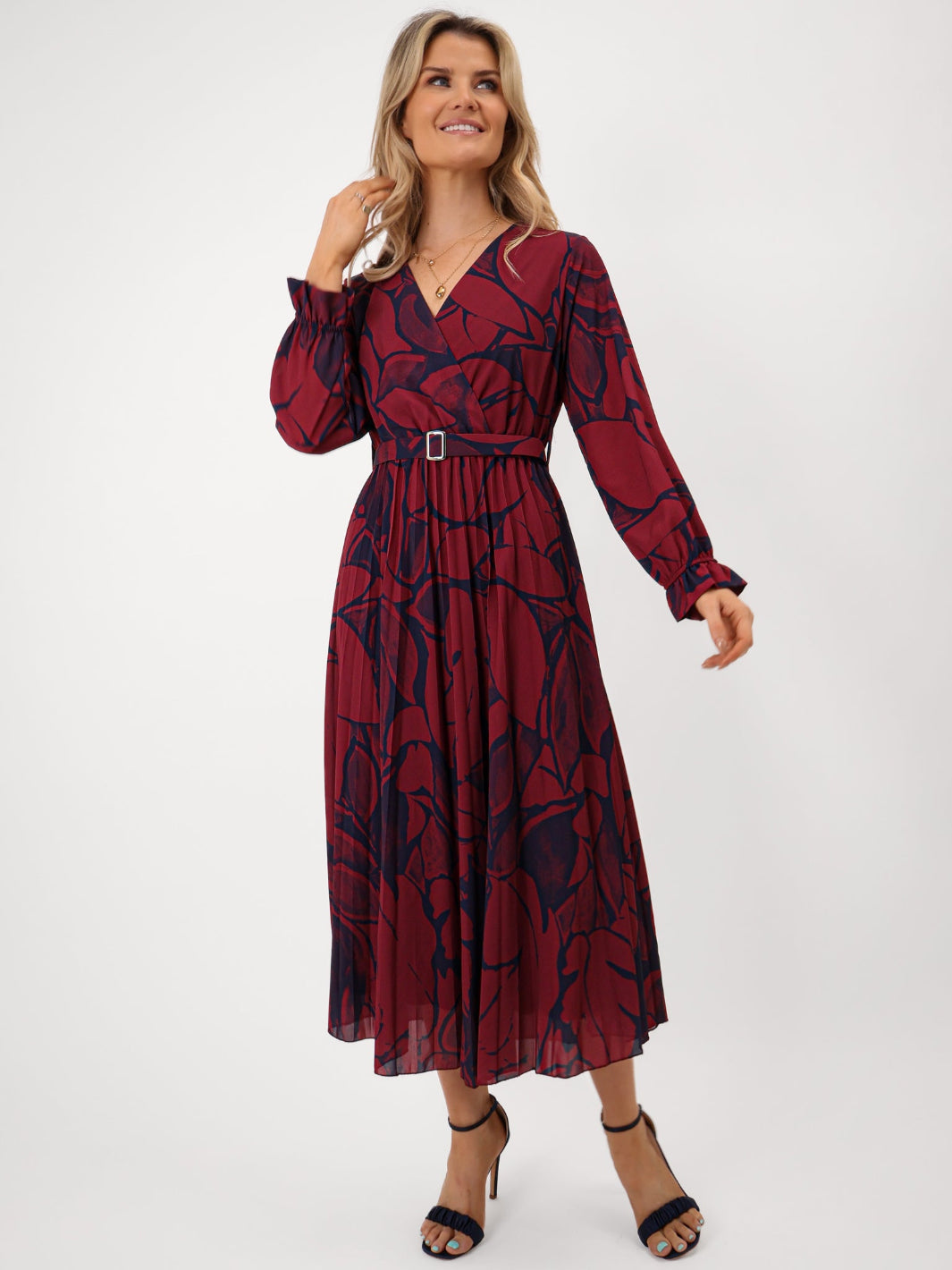 Woman wearing a red and black patterned dress on a white background